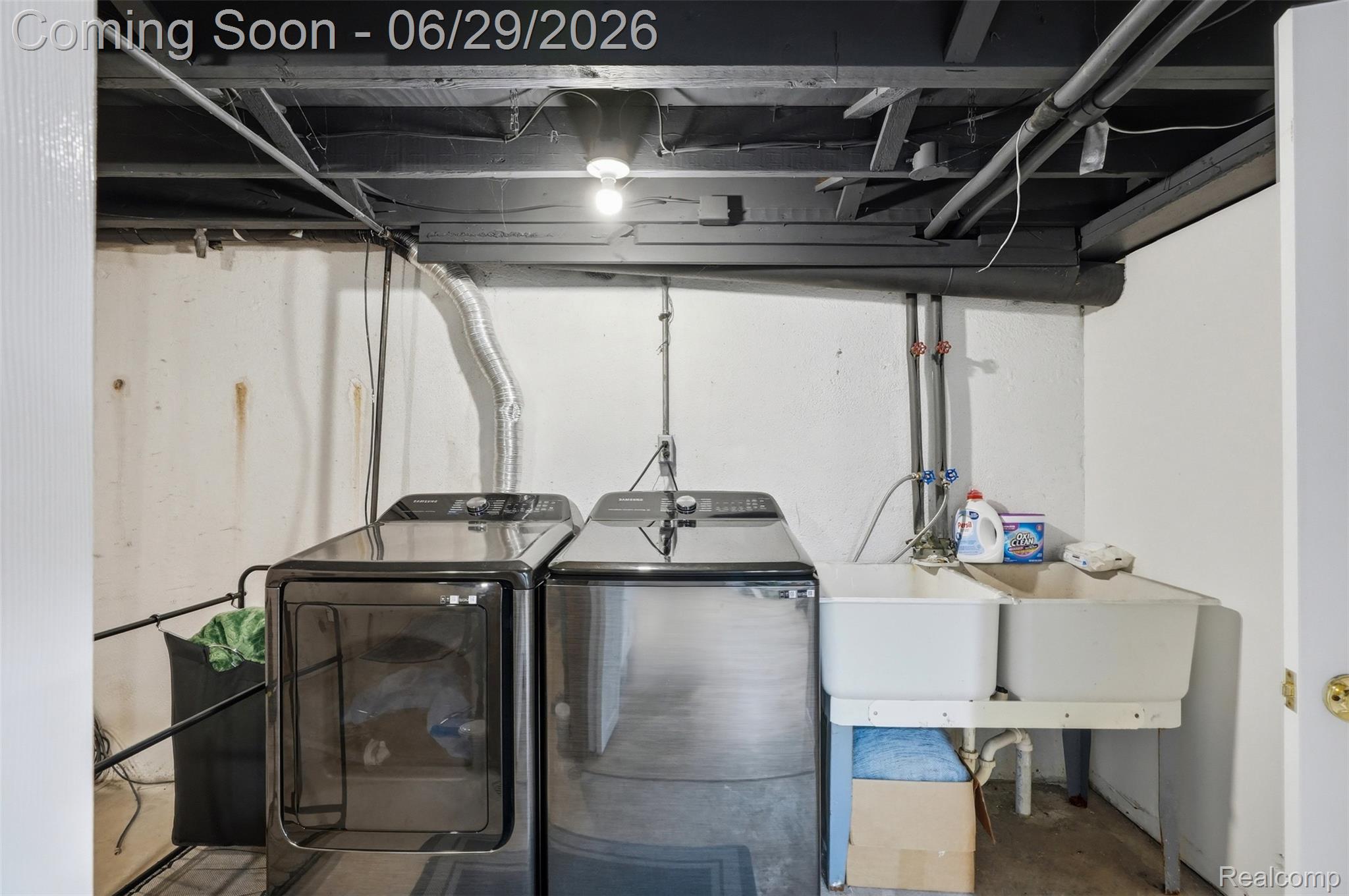 45179 Rudgate Road Canton, MI 48188 - Photo 26 of 48 Laundry area featuring exposed ceiling joists, a utility sink, and white walls