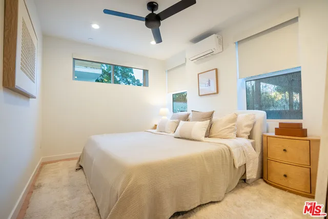 a bathroom with a sink toilet a mirror and shower