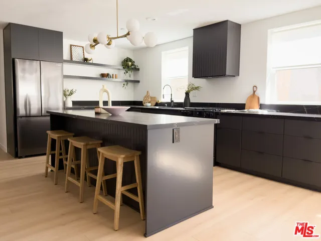 a kitchen with stainless steel appliances granite countertop a sink and a stove