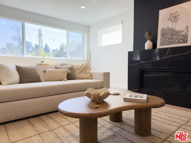 a living room with furniture and a lamp