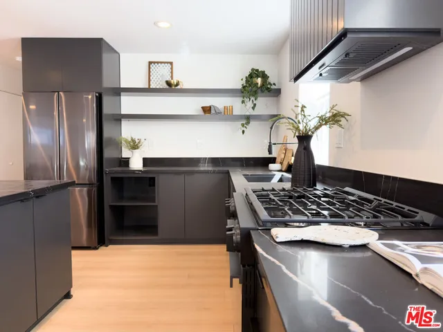 a kitchen with a stove and a refrigerator