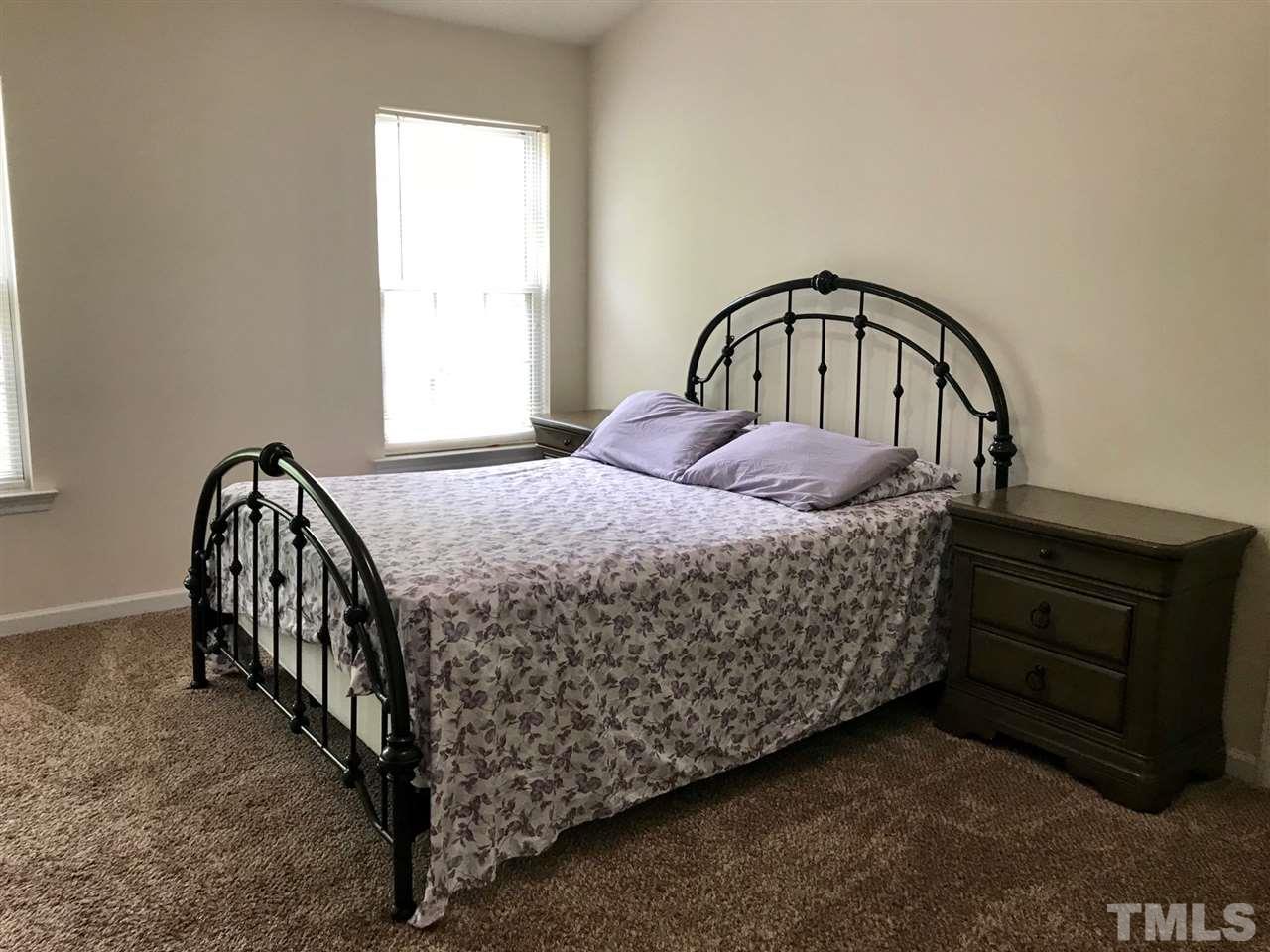 8612 Neuse Hunter Drive Raleigh, NC 27616 - Photo 16 of 23 a bedroom with a bed and a window
