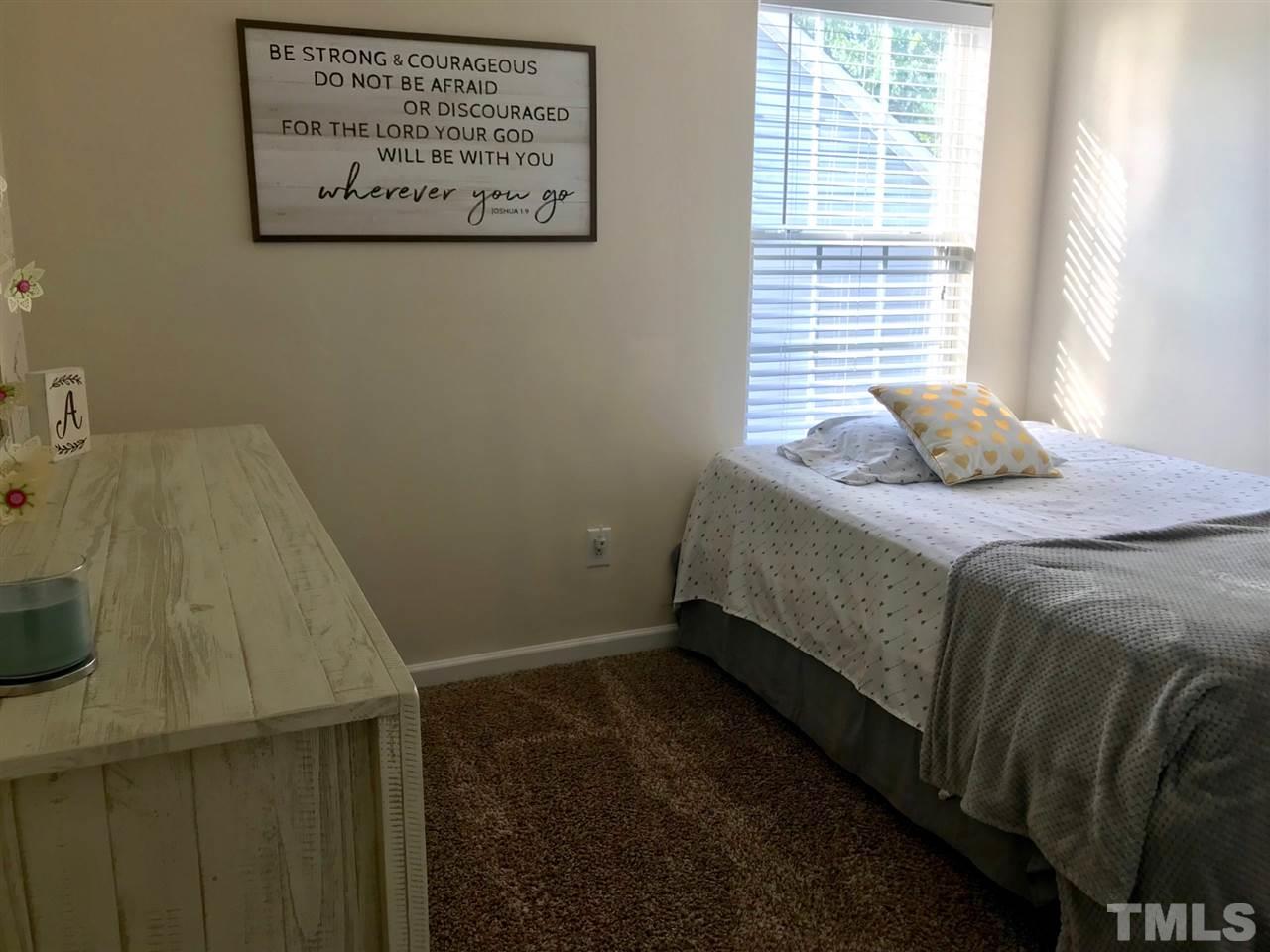 8612 Neuse Hunter Drive Raleigh, NC 27616 - Photo 17 of 23 a bedroom with a bed and a window