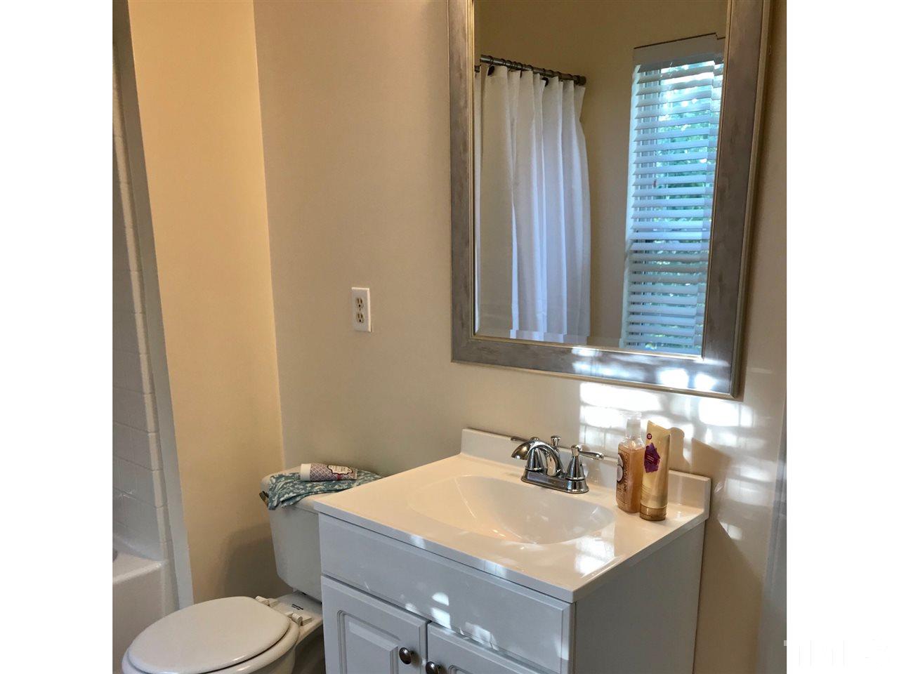 8612 Neuse Hunter Drive Raleigh, NC 27616 - Photo 18 of 23 a bathroom with a sink toilet and mirror