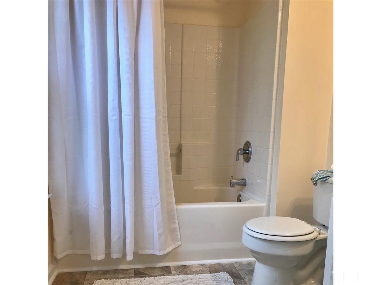 8612 Neuse Hunter Drive Raleigh, NC 27616 - Photo 19 of 23 a bathroom with a toilet and a bathtub