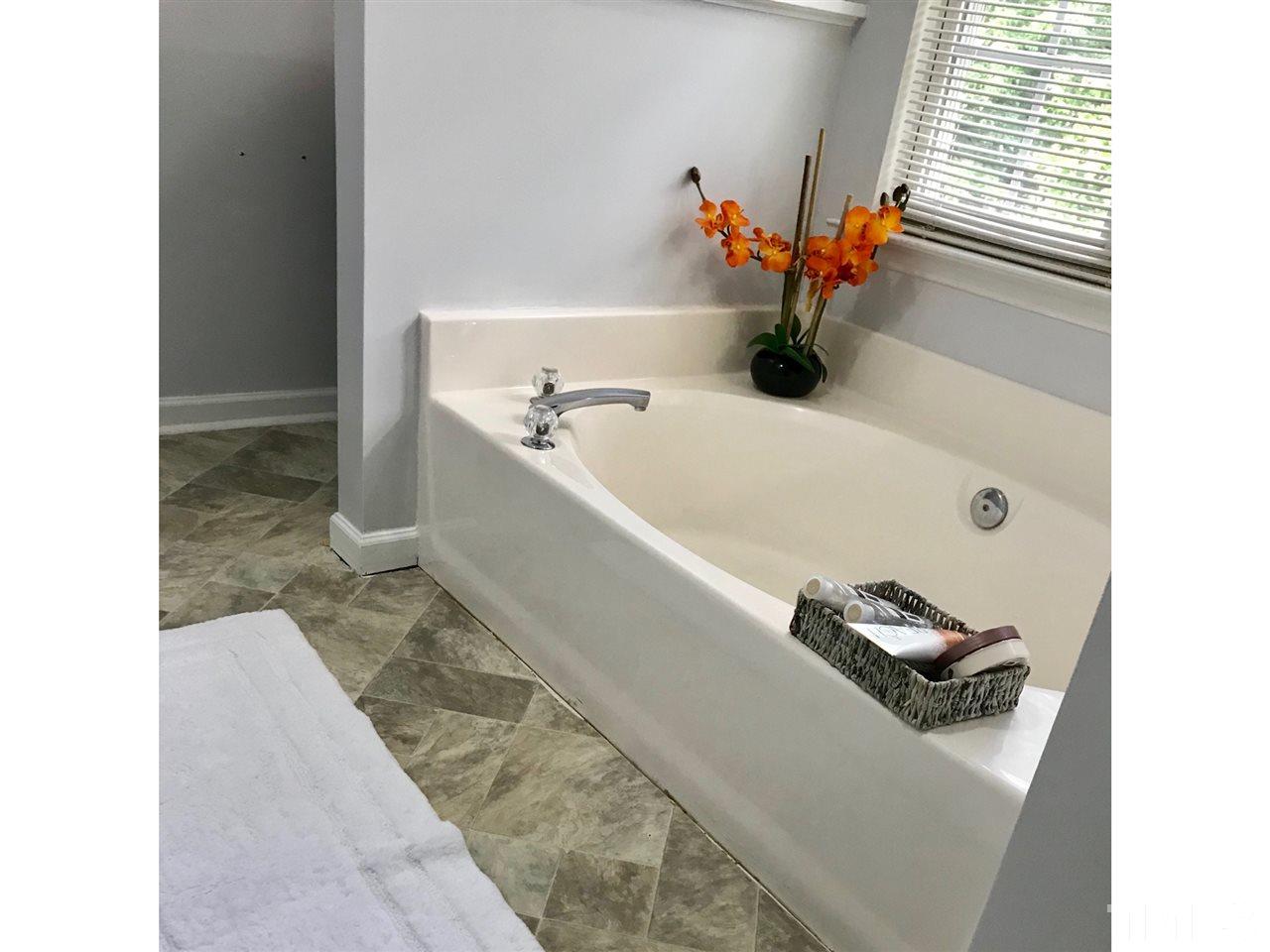 8612 Neuse Hunter Drive Raleigh, NC 27616 - Photo 20 of 23 a bathroom with a tub and a sink