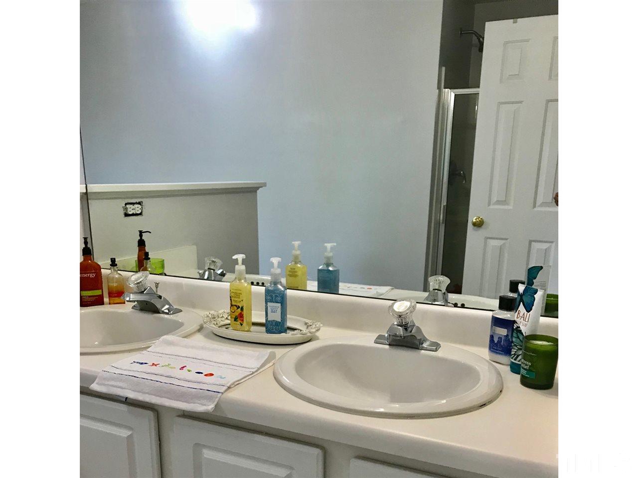 8612 Neuse Hunter Drive Raleigh, NC 27616 - Photo 21 of 23 a bathroom with a sink and a mirror