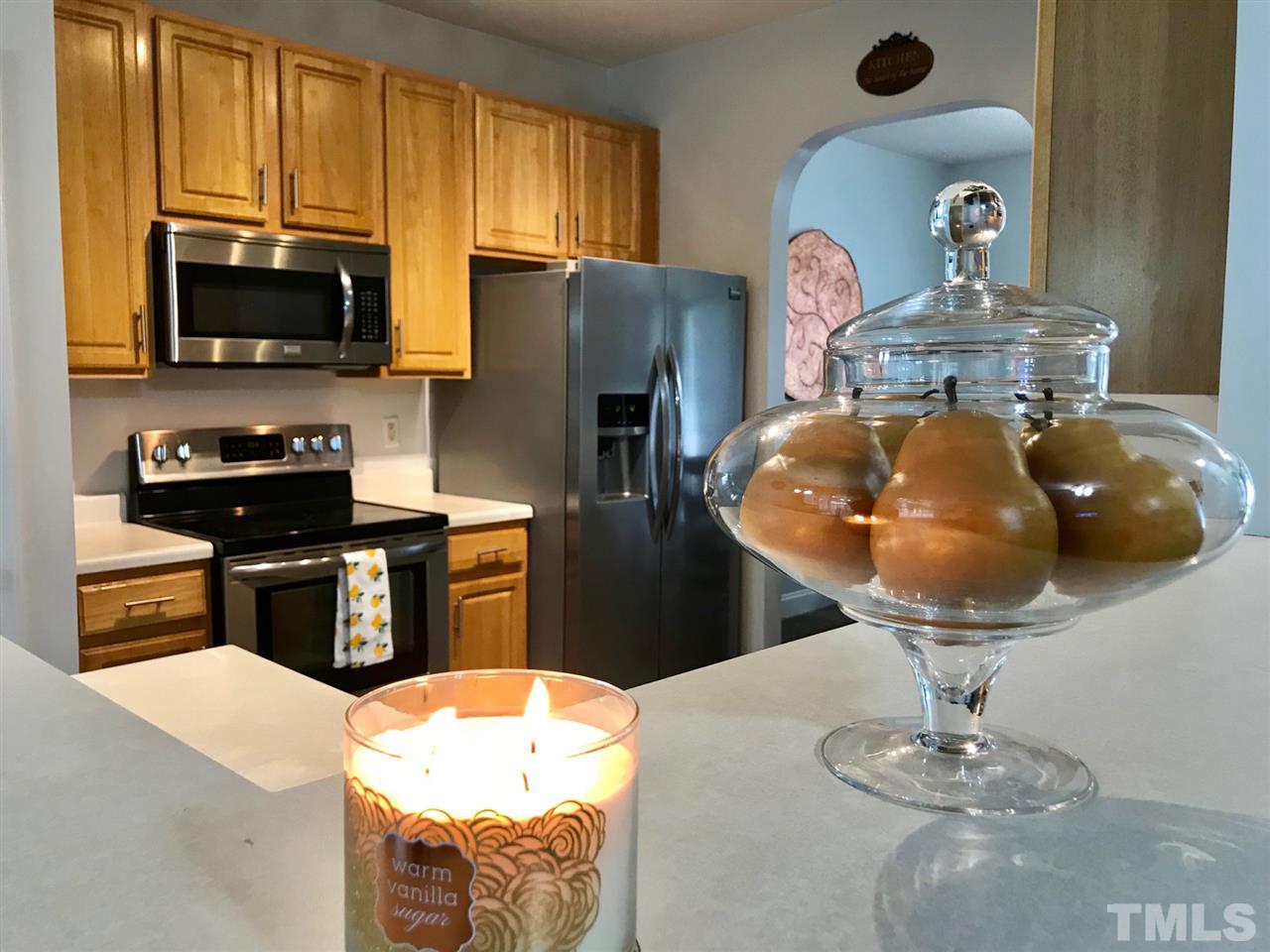 8612 Neuse Hunter Drive Raleigh, NC 27616 - Photo 8 of 23 a kitchen with a appliances and chandelier