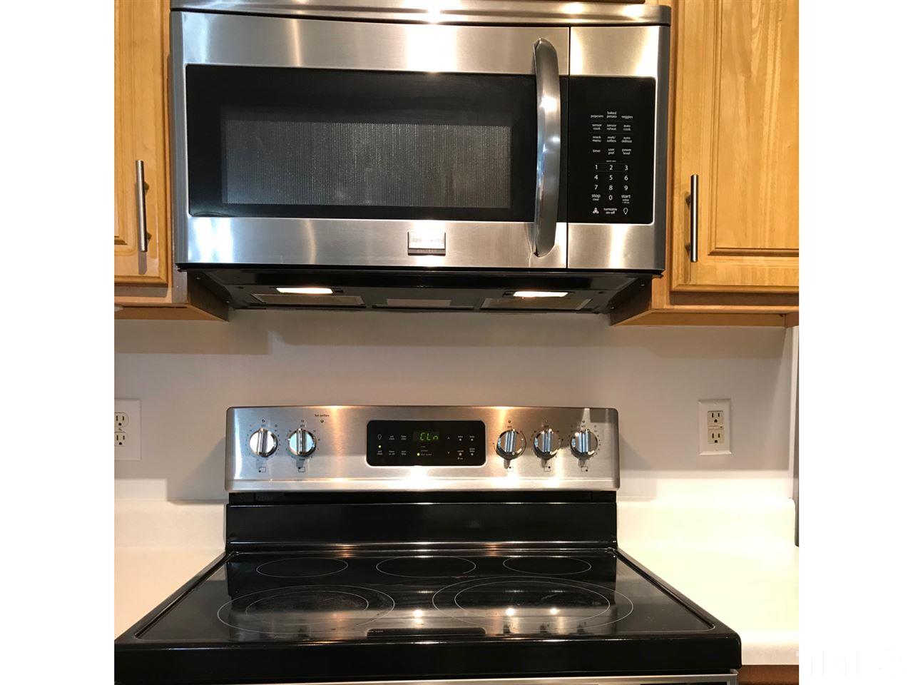 8612 Neuse Hunter Drive Raleigh, NC 27616 - Photo 10 of 23 a kitchen with a stove and a microwave