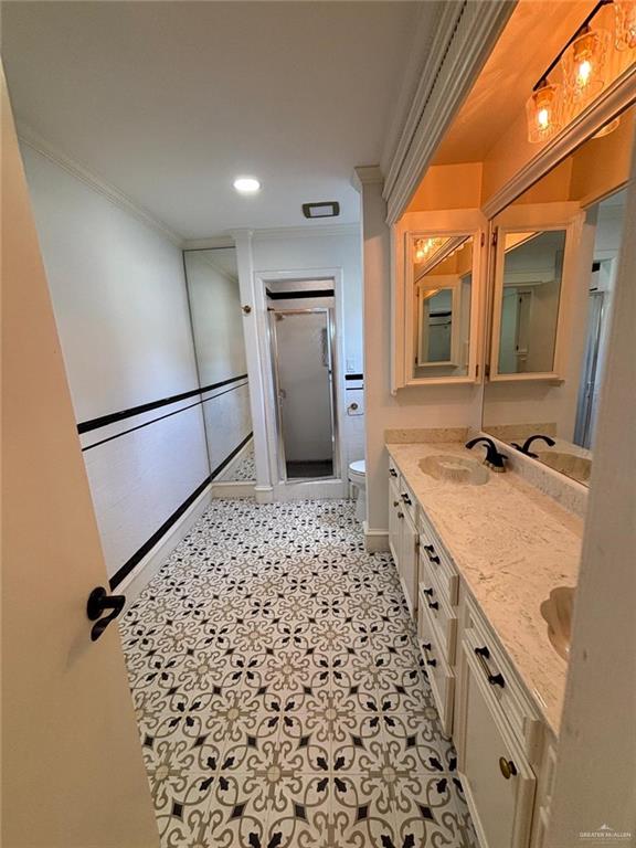 101 Harvey Street McAllen, TX 78501 - Photo 10 of 14 a bathroom with a granite countertop sink a large mirror and a shower