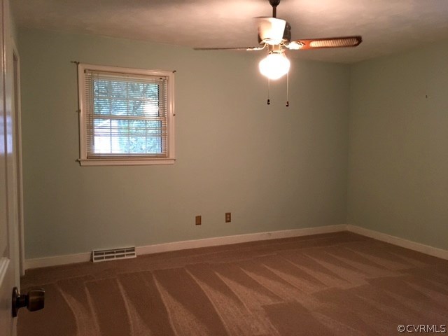 11420 Chalkley Road Chester, VA 23831 - Photo 19 of 43 an empty room with a window and a fan