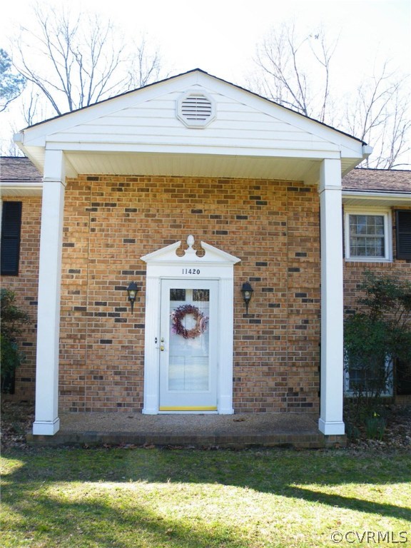 11420 Chalkley Road Chester, VA 23831 - Photo 2 of 43 a view of a stone house with a small yard