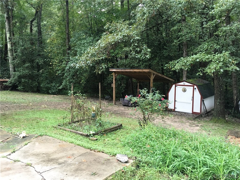 11420 Chalkley Road Chester, VA 23831 - Photo 31 of 43 a backyard of a house with garden and trees