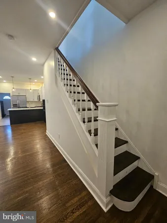 a view of entryway and hall with wooden floor