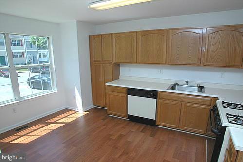 3546 Corn Stream Road Randallstown, MD 21133 - Photo 1 of 21 a kitchen with granite countertop wooden cabinets a sink and a window