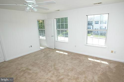 3546 Corn Stream Road Randallstown, MD 21133 - Photo 2 of 21 an empty room with windows and fan