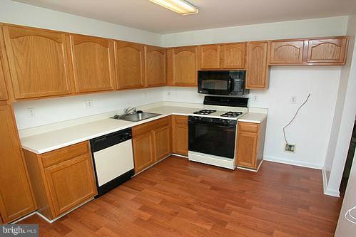 3546 Corn Stream Road Randallstown, MD 21133 - Photo 15 of 21 a kitchen with stainless steel appliances granite countertop a stove a sink and a microwave
