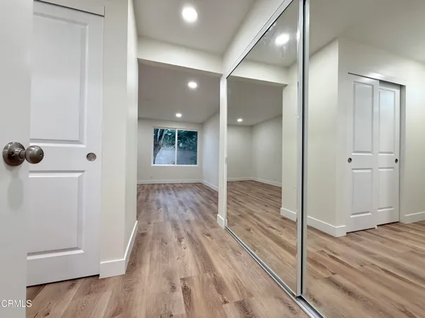 a view of a hallway with wooden floor