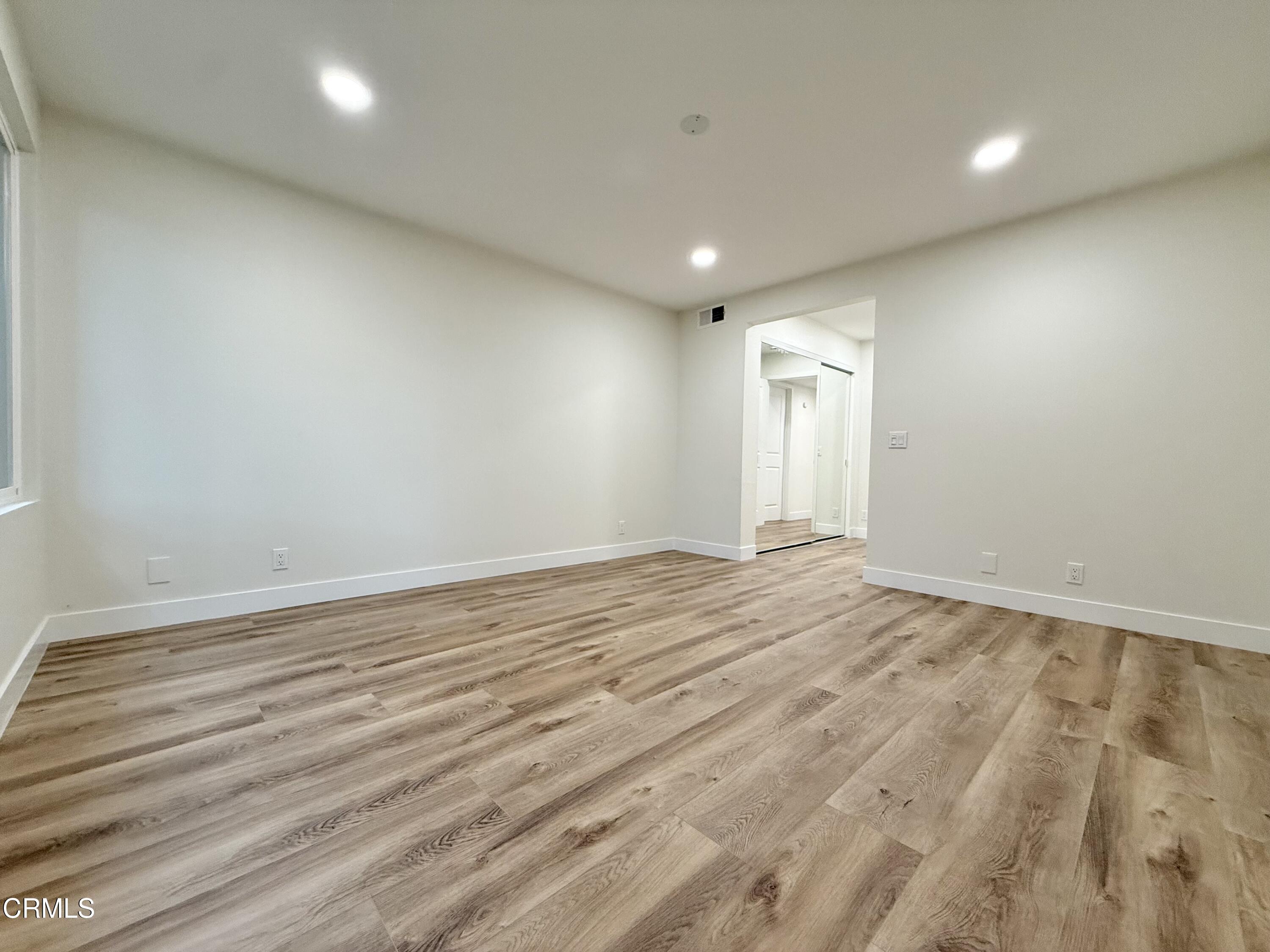 2124 Pamela Street Oxnard, CA 93036 - Photo 21 of 23 an empty room with wooden floor and windows