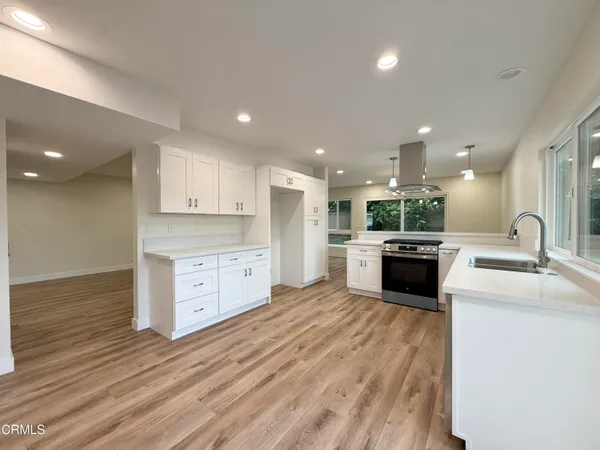a open kitchen with a sink and cabinets
