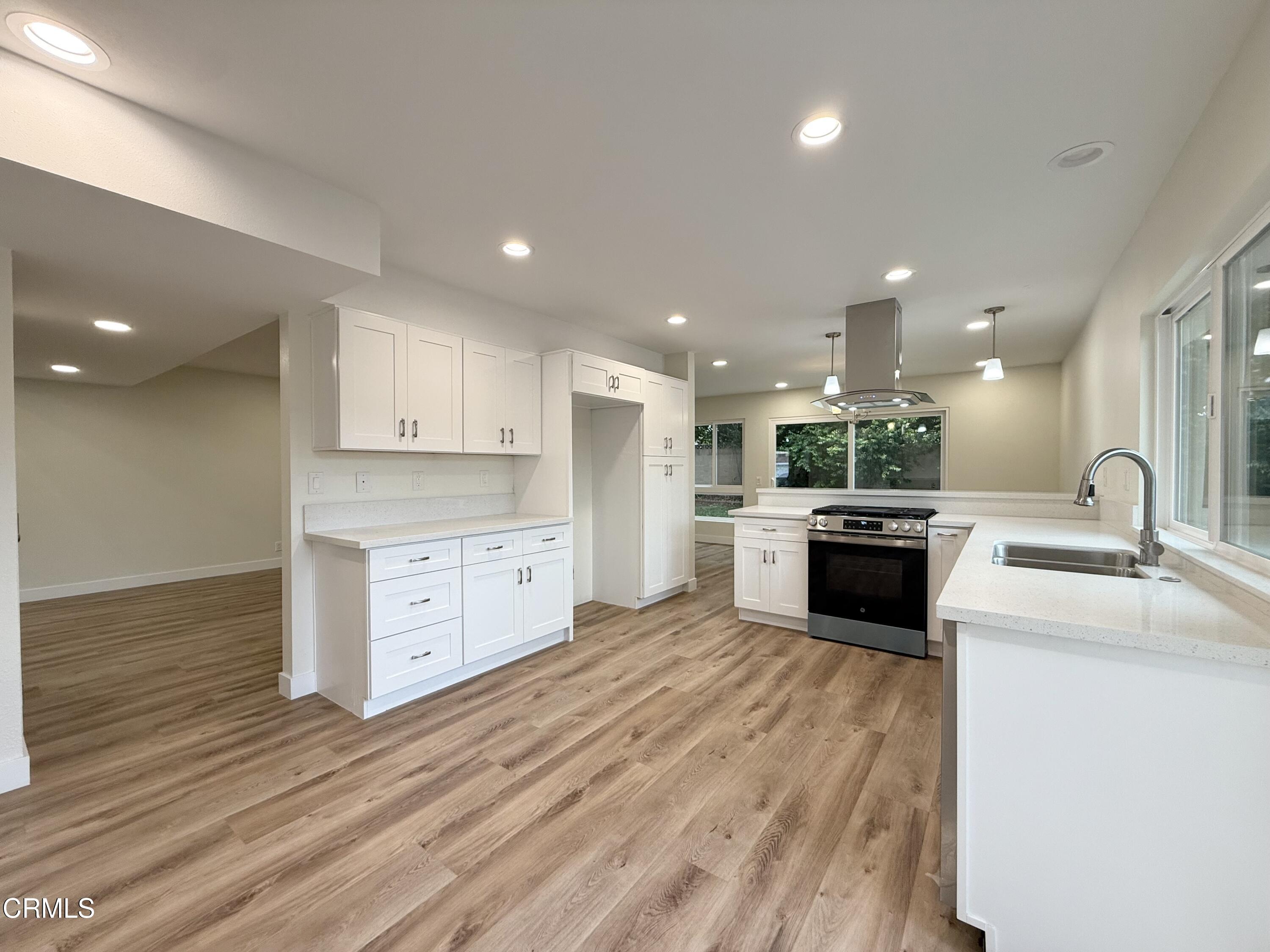 2124 Pamela Street Oxnard, CA 93036 - Photo 6 of 23 a open kitchen with a sink and cabinets