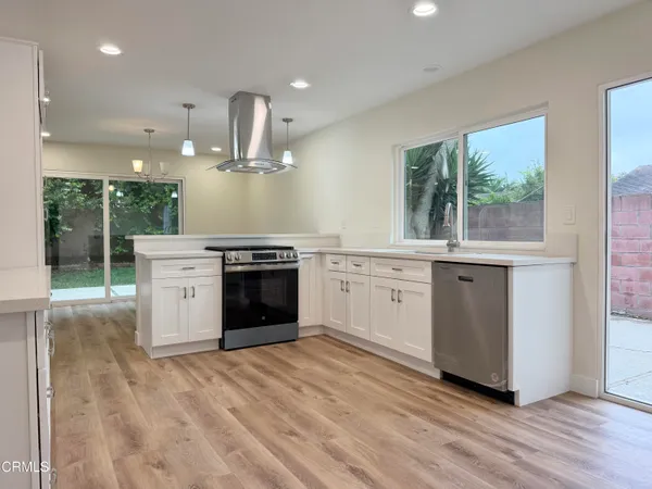 a kitchen with a stove top oven and sink