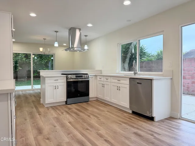 a kitchen with a stove top oven and sink