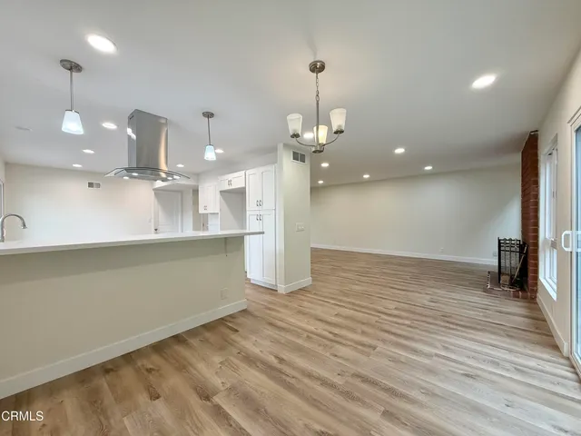 a view of a kitchen with a sink and chandelier