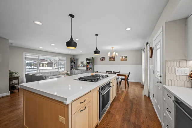a kitchen with a stove sink and cabinets