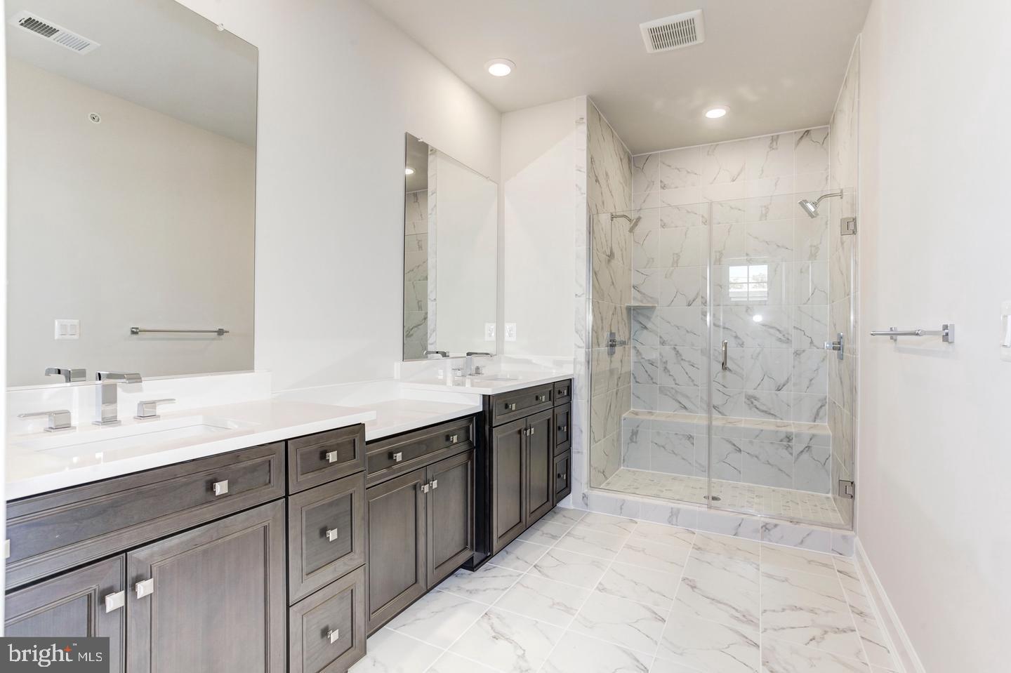 12923 Sunrise Ridge Alley Herndon, VA 20171 - Photo 19 of 25 a bathroom with a shower sink double and mirror