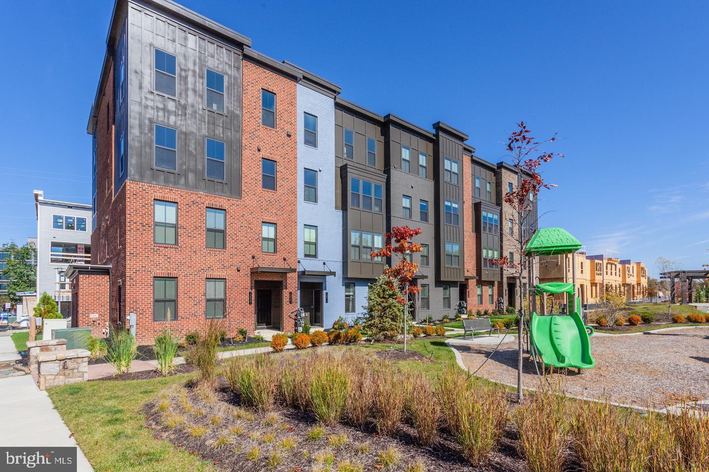 12923 Sunrise Ridge Alley Herndon, VA 20171 - Photo 23 of 25 a view of a building with a yard