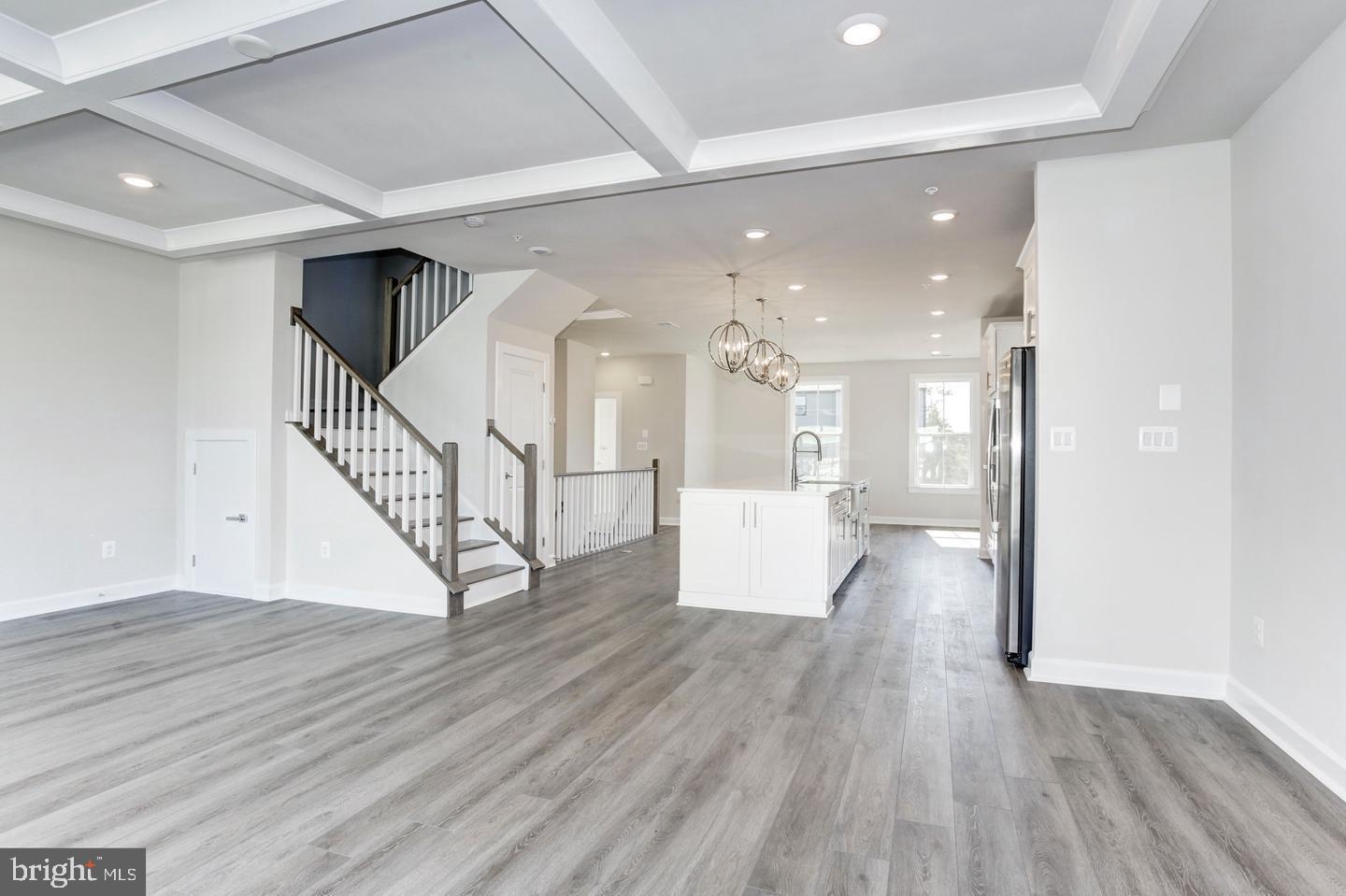 12923 Sunrise Ridge Alley Herndon, VA 20171 - Photo 6 of 25 a view of a hallway with wooden floor and entryway