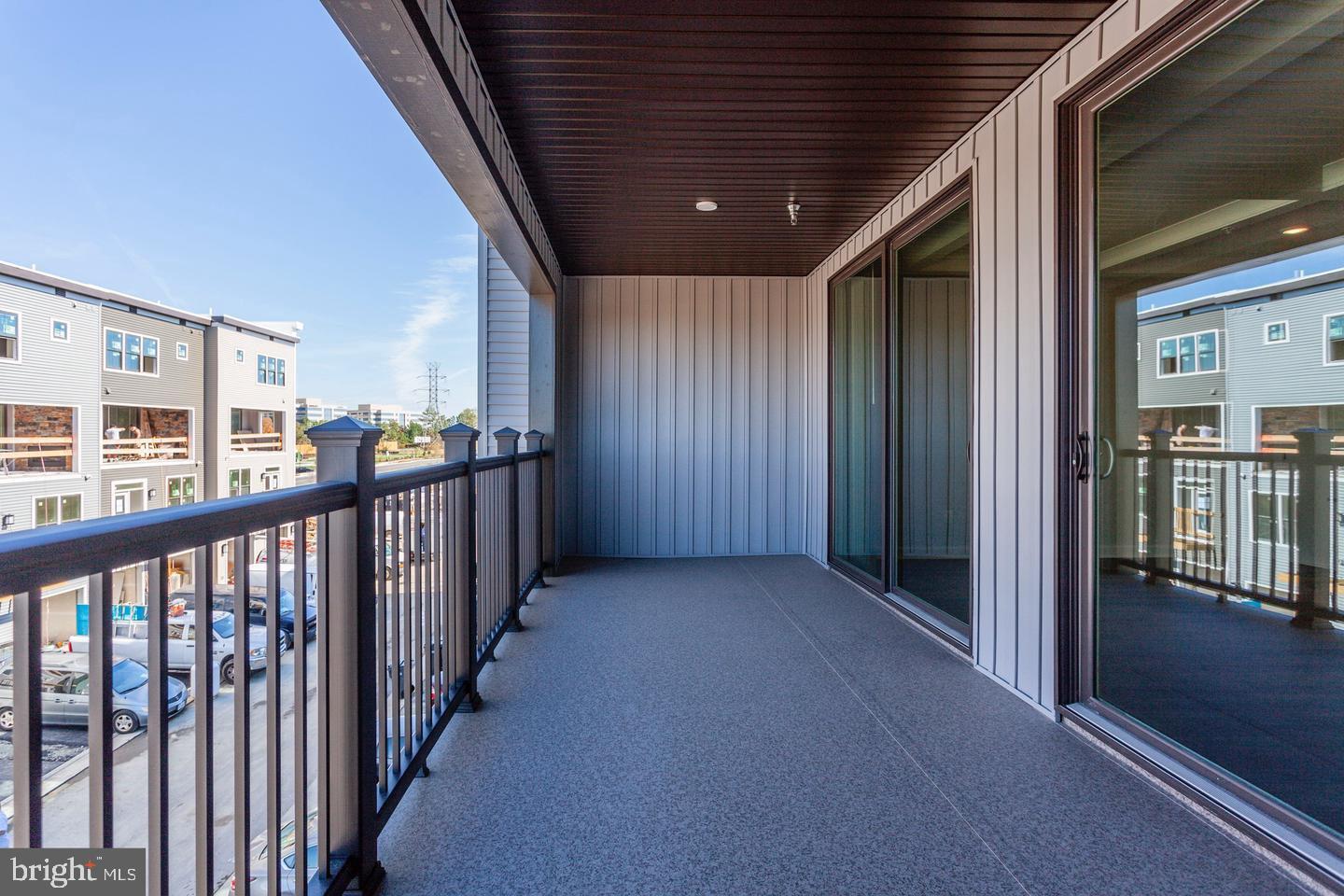 12923 Sunrise Ridge Alley Herndon, VA 20171 - Photo 8 of 25 a view of a porch with wooden floor and windows