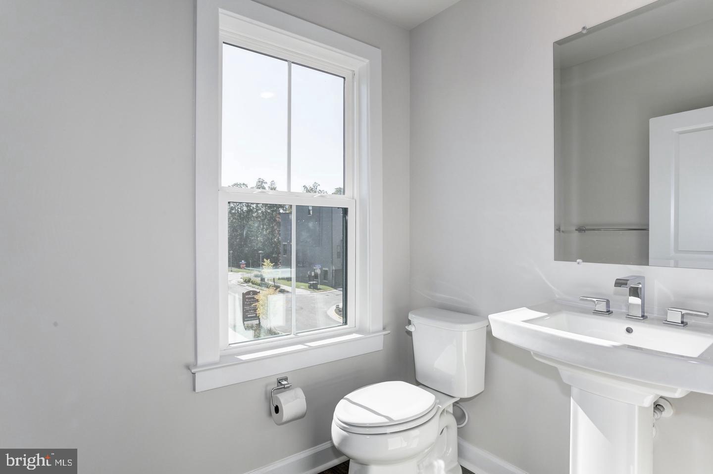 12923 Sunrise Ridge Alley Herndon, VA 20171 - Photo 10 of 25 a bathroom with a sink a toilet and a window