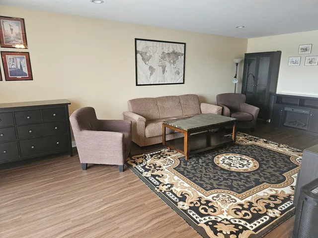 a living room with furniture and a rug