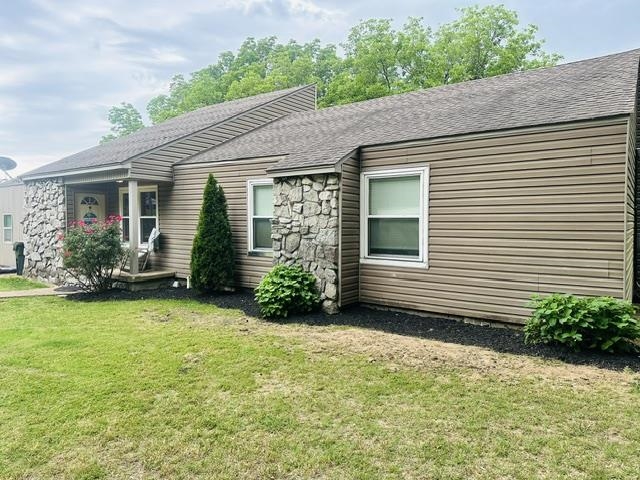 a view of a house with a yard and plants