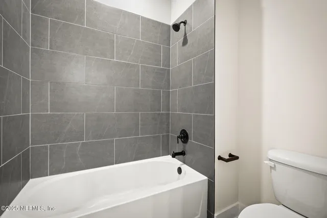 a bathroom with a bathtub and a toilet