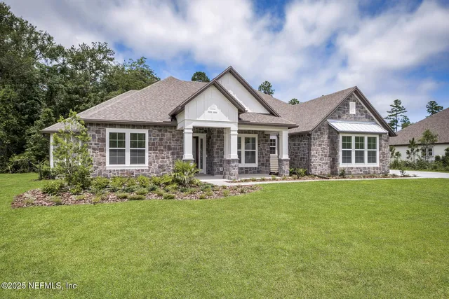 a front view of a house with a garden and porch
