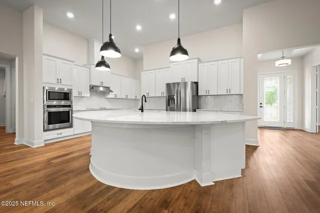 a large kitchen with stainless steel appliances kitchen island a large island in the center