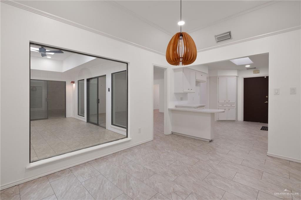 409 Tyler Avenue McAllen, TX 78503 - Photo 11 of 21 an empty room with wooden floor and windows