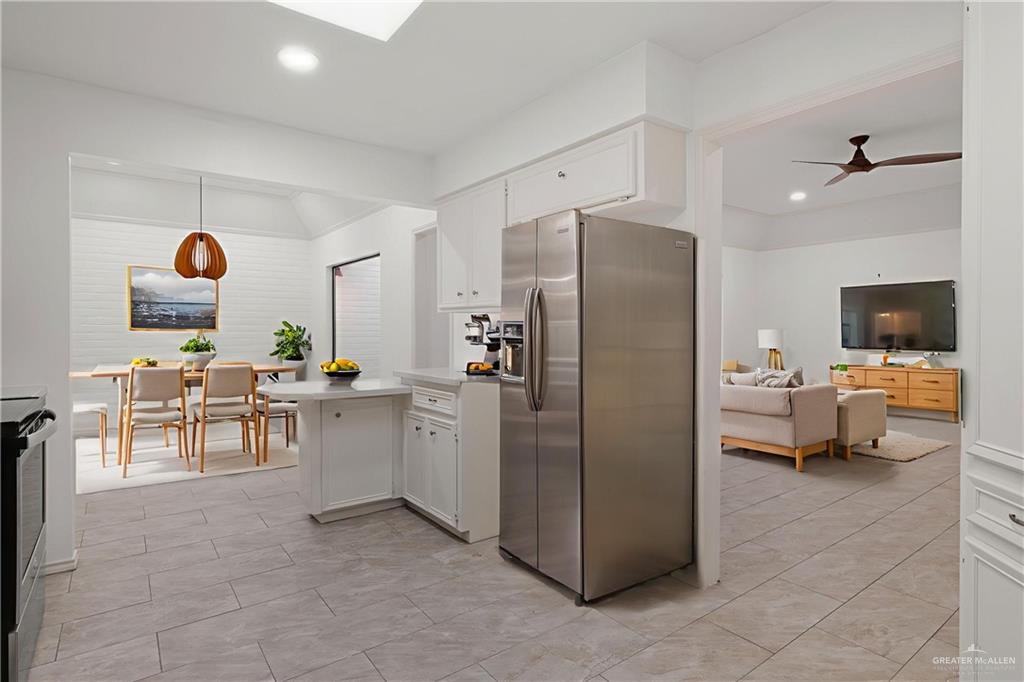 409 Tyler Avenue McAllen, TX 78503 - Photo 13 of 21 a living room with furniture a flat screen tv and a refrigerator