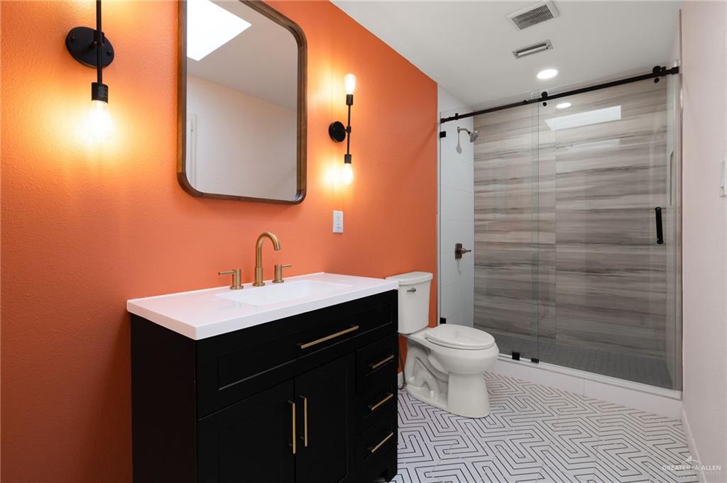 409 Tyler Avenue McAllen, TX 78503 - Photo 17 of 21 a bathroom with a sink a toilet and shower