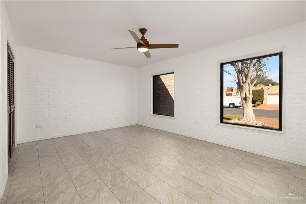 409 Tyler Avenue McAllen, TX 78503 - Photo 20 of 21 an empty room with windows and ceiling fan