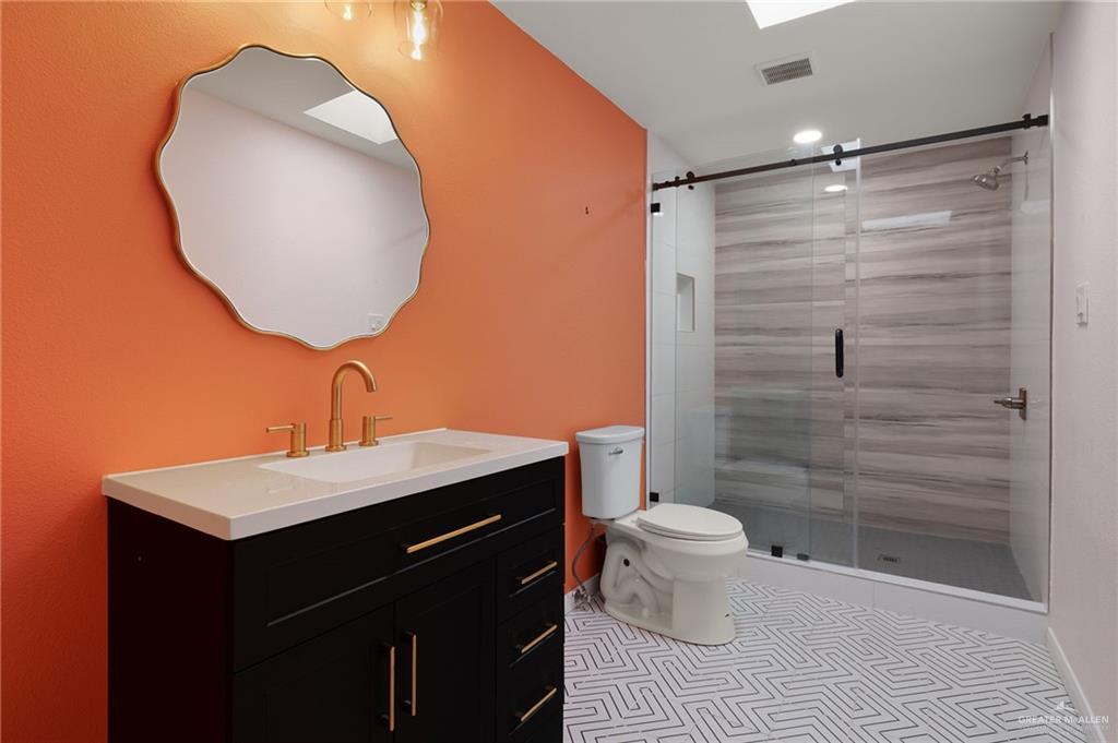 409 Tyler Avenue McAllen, TX 78503 - Photo 21 of 21 a bathroom with a sink toilet and shower