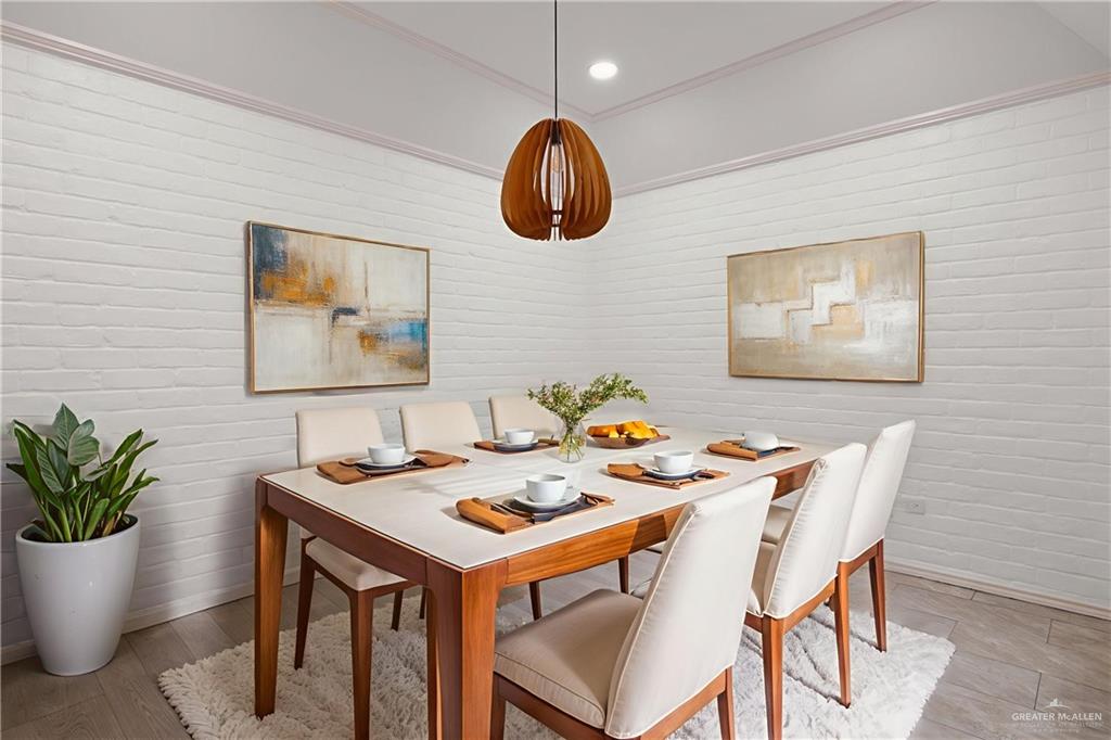 409 Tyler Avenue McAllen, TX 78503 - Photo 8 of 21 a dining room with a table chairs and a potted plant