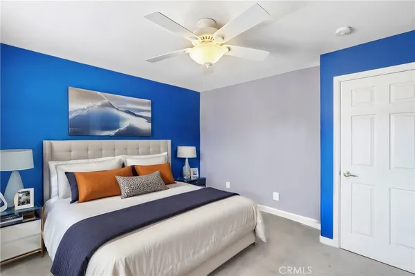 a bedroom with a large bed and a flat screen tv