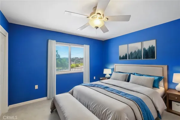 a bedroom with a large bed and a window
