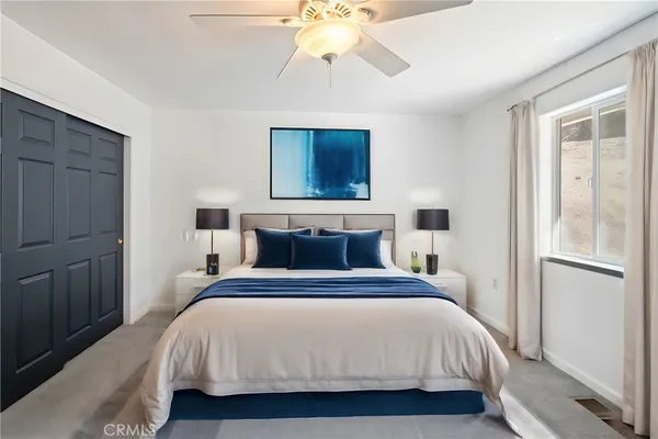 a bedroom with a large bed and a tv