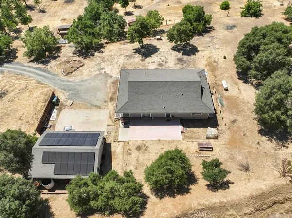 an aerial view of a house with a yard