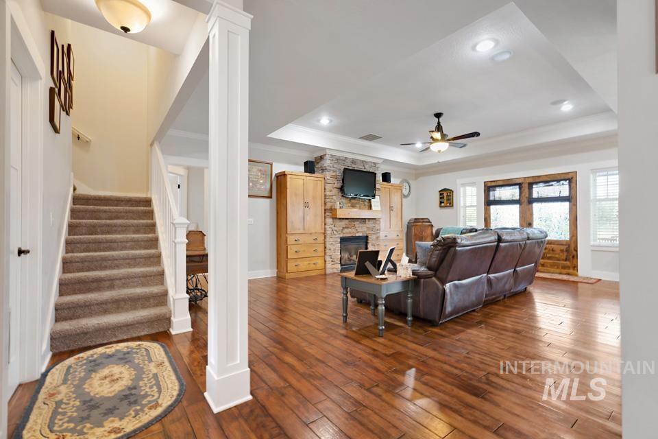 8271 Washoe Road Fruitland, ID 83619 - Photo 14 of 29 Spacious interior featuring wood-finish flooring and a stone-clad fireplace